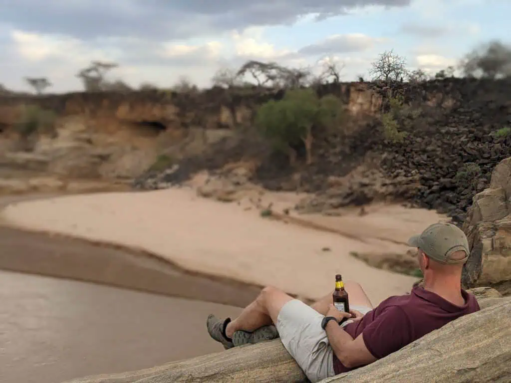 Having sundowners on the rocks over the river