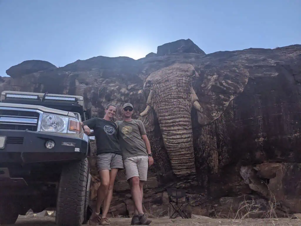 man and woman in front of the elephant mural in samburu