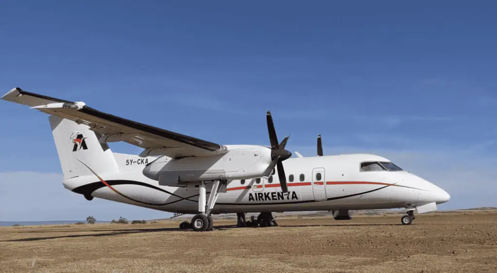 Light aircraft on open field, used for safari trips and aerial tours in Africa, showcasing aerial travel services for wildlife safaris and adventure tourism.