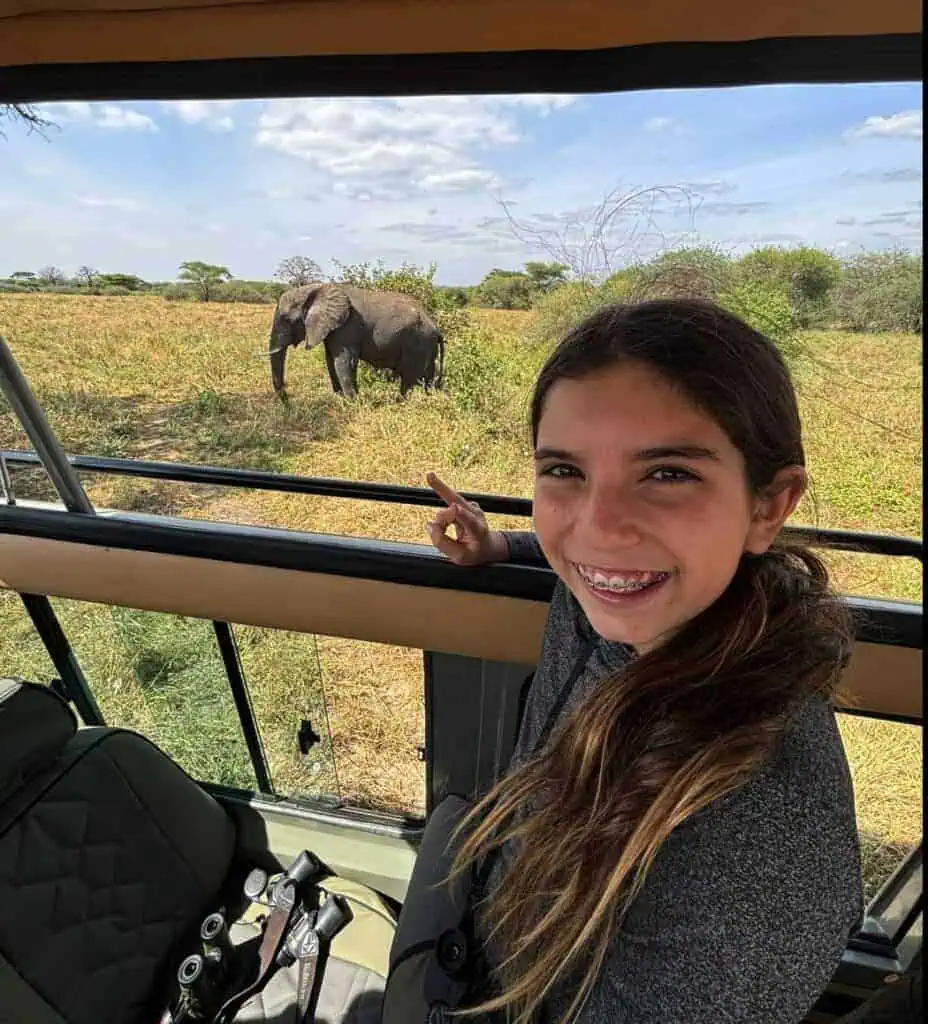 Elephant safari in Africa, young girl enjoying wildlife game drive during safari adventure on the African plains.