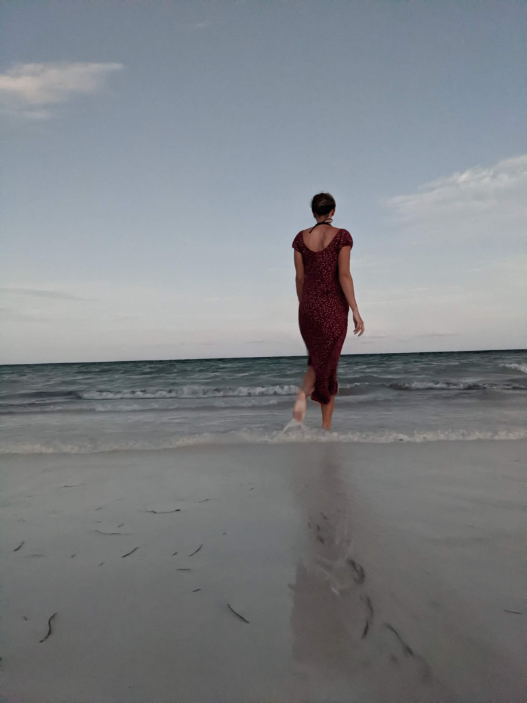 Me walking into the sea at dusk on Diani Beach, Kenya