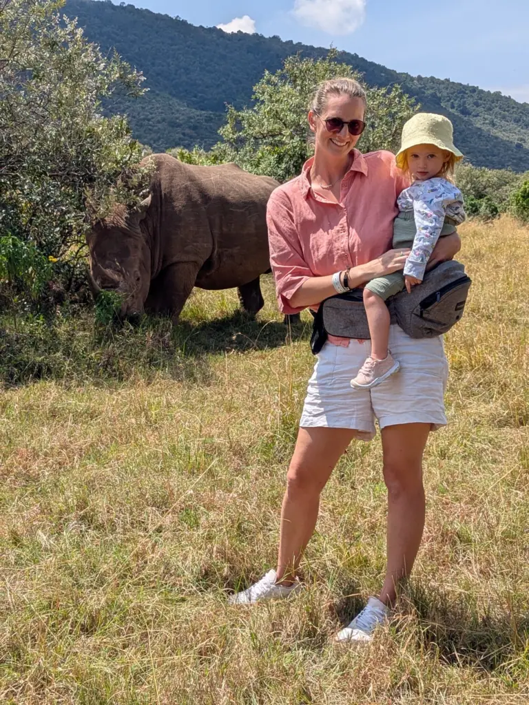 Me and my daughter with a rhino behind us in the Mara
